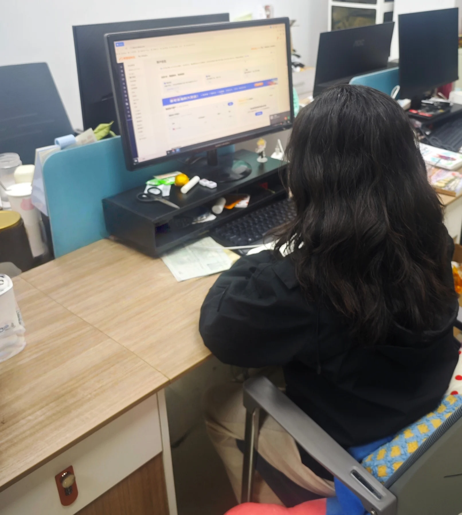 Woman working at a computer desk