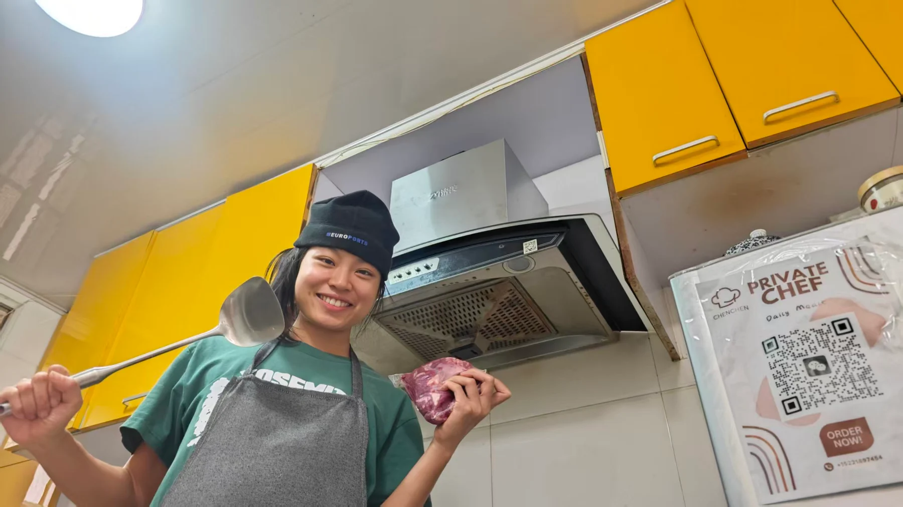 Person holding food in a kitchen