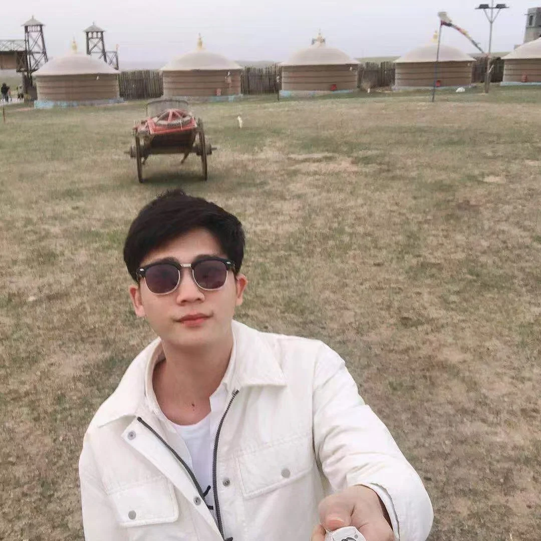 Young man in sunglasses sitting outdoors