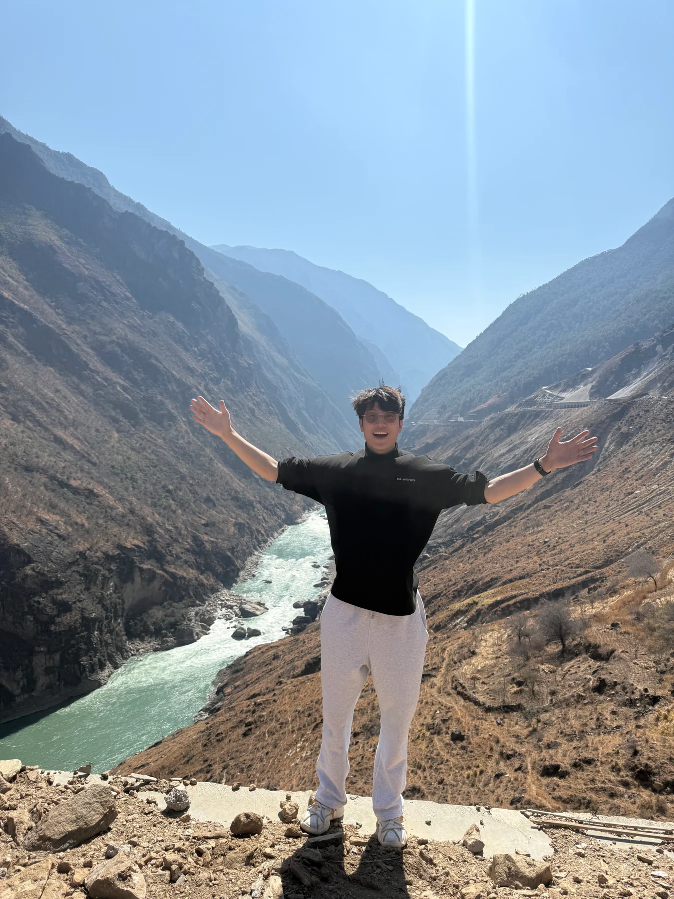 Man standing above a mountain river