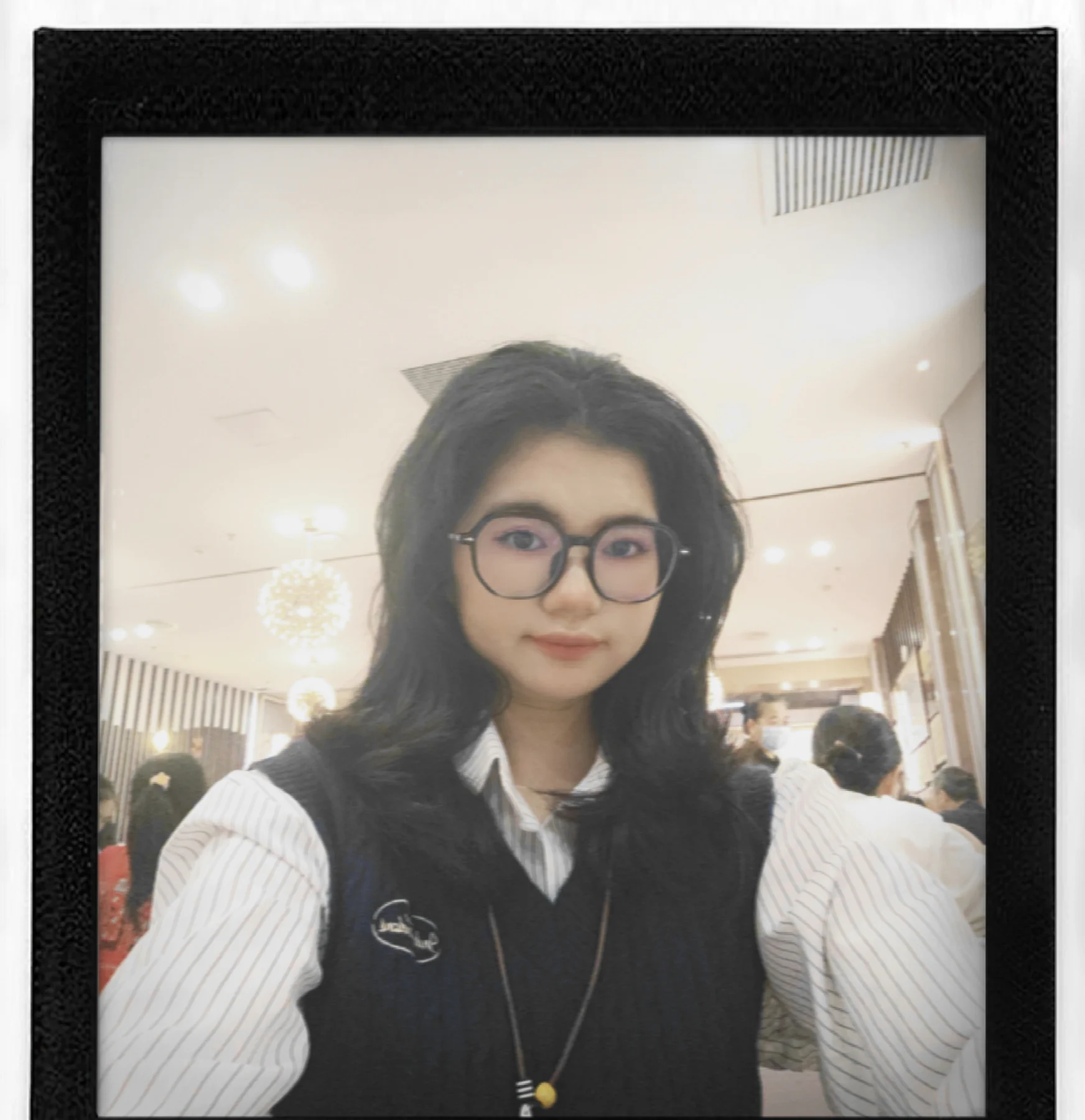 Woman wearing glasses seated at a restaurant